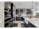 Modern kitchen features dark cabinets, stainless steel appliances, a farmhouse sink, and stylish backsplash at 2518 Veronella St, Henderson, NV 89044