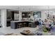 Spacious kitchen featuring dark cabinets, stainless steel appliances, a large island, and an adjacent dining area at 2518 Veronella St, Henderson, NV 89044