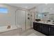 Spa-like bathroom with soaking tub, frameless glass shower, and double sink vanity at 2518 Veronella St, Henderson, NV 89044
