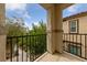 A view of a balcony with black iron railings and a view of the surrounding landscape and sky at 2606 Marvel Astoria St, Henderson, NV 89044