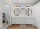 Modern bathroom featuring double sinks, sleek vanities, and stylish lighting fixtures at 2606 Marvel Astoria St, Henderson, NV 89044