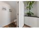 Cozy half bathroom featuring contemporary plant decor, a white door, and neutral wall art at 2606 Marvel Astoria St, Henderson, NV 89044