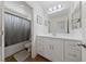 Well-lit bathroom with a shower-tub combo, modern vanity, and a large mirror offers functionality and style at 2606 Marvel Astoria St, Henderson, NV 89044