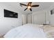 Cozy bedroom with a ceiling fan, closet, and a wall-mounted TV provides a relaxing retreat at 2606 Marvel Astoria St, Henderson, NV 89044
