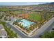 Aerial view of a community pool area, baseball field, and manicured landscaping at 2606 Marvel Astoria St, Henderson, NV 89044