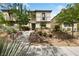 Inviting two-story home with well-manicured landscaping and charming front yard with desert-friendly foliage at 2606 Marvel Astoria St, Henderson, NV 89044