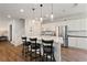 Bright, modern kitchen features white cabinets, stainless steel appliances, and island with bar seating at 2606 Marvel Astoria St, Henderson, NV 89044