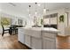 Bright kitchen with a large island, modern faucet, stainless steel appliances, and wood-look flooring at 2606 Marvel Astoria St, Henderson, NV 89044