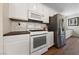 Modern kitchen with white cabinets, stainless steel appliances, and stylish backsplash at 2606 Marvel Astoria St, Henderson, NV 89044