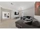 Spacious living room featuring a comfortable grey sectional sofa and a modern entertainment center at 2606 Marvel Astoria St, Henderson, NV 89044