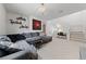 Bright living room with comfortable grey sectional, artwork, a staircase, and a desk at 2606 Marvel Astoria St, Henderson, NV 89044