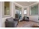 A covered patio with comfortable seating and an inviting view of the interior at 2606 Marvel Astoria St, Henderson, NV 89044