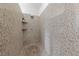 Luxurious walk-in shower with granite-style walls and modern fixtures at 2606 Marvel Astoria St, Henderson, NV 89044
