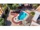 An aerial view of a home's backyard featuring a large pool with a diving board and patio at 2771 S Buffalo Dr, Las Vegas, NV 89117