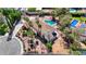 An aerial view of a luxury home featuring a sparkling pool, lush landscaping, and a large driveway at 2771 S Buffalo Dr, Las Vegas, NV 89117