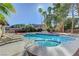 A backyard featuring a sparkling in-ground pool and spa with lounge chairs and mature landscaping at 2771 S Buffalo Dr, Las Vegas, NV 89117