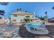 A lovely backyard features a pool surrounded by rock features, lounge chairs and manicured landscaping at 2771 S Buffalo Dr, Las Vegas, NV 89117