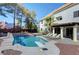 An attractive backyard featuring a beautiful pool with a diving board and lounge chairs at 2771 S Buffalo Dr, Las Vegas, NV 89117