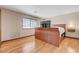 Bright bedroom features hardwood floors and a TV mounted on a modern headboard at 2771 S Buffalo Dr, Las Vegas, NV 89117