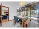 Bright dining area with a rustic table, natural light, and views of the pool at 2771 S Buffalo Dr, Las Vegas, NV 89117