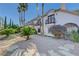 Well-kept front yard featuring stone pavers, a variety of plants, and trees at 2771 S Buffalo Dr, Las Vegas, NV 89117