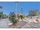 Beautifully landscaped front yard featuring pavers, greenery, and mature trees at 2771 S Buffalo Dr, Las Vegas, NV 89117