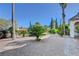 Lush landscaping surrounds the home with various plants, trees, and decorative stone at 2771 S Buffalo Dr, Las Vegas, NV 89117