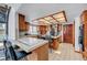 Well-lit kitchen featuring an island with bar seating and updated appliances at 2771 S Buffalo Dr, Las Vegas, NV 89117