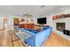 Inviting living room with a comfortable blue sectional sofa, fireplace, and a stylish wet bar for entertaining at 2771 S Buffalo Dr, Las Vegas, NV 89117