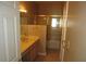 Well-lit bathroom featuring a sink and cabinet, along with a shower over bath installation with a glass door at 2830 Queens Courtyard Dr, Las Vegas, NV 89109