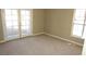 Cozy bedroom with a double French door and window that offer natural light and fresh air at 2830 Queens Courtyard Dr, Las Vegas, NV 89109