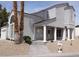 Inviting single-Gathering home with stucco exterior, desert landscaping, and a columned front porch entrance at 2830 Queens Courtyard Dr, Las Vegas, NV 89109