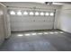 Spacious two-car garage featuring a high ceiling and a large overhead door at 2830 Queens Courtyard Dr, Las Vegas, NV 89109