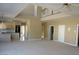 Open-concept living space flows into the kitchen, showcasing high ceilings and abundant natural light at 2830 Queens Courtyard Dr, Las Vegas, NV 89109