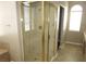 Shower room featuring glass door, and bathtub; complemented by tiled walls and ample space at 2830 Queens Courtyard Dr, Las Vegas, NV 89109