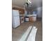 Open concept kitchen with white appliances, tile flooring and wood cabinets at 2839 Kensington St, Las Vegas, NV 89156
