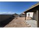 Desert landscaped backyard with concrete block wall, patio, and grill at 2845 Kensington St, Las Vegas, NV 89156
