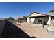 Expansive backyard featuring a covered patio, brick elements, and potential for landscaping at 2845 Kensington St, Las Vegas, NV 89156