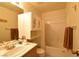 A bathroom with a single sink, bathtub with curtain, and floral decorations at 2845 Kensington St, Las Vegas, NV 89156