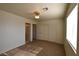 A carpeted bedroom with closet, doors, and a window for natural light at 2845 Kensington St, Las Vegas, NV 89156