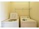 Laundry room with white washing machine and dryer with metal shelving at 2845 Kensington St, Las Vegas, NV 89156