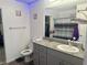 A bathroom with gray cabinets, granite counters, and decor to make the space feel like home at 2872 Atomic Tangerine Way # 2, Las Vegas, NV 89183