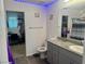 Bright bathroom featuring a modern gray vanity and illuminated by blue LED strip lights at 2872 Atomic Tangerine Way # 2, Las Vegas, NV 89183