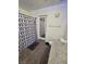 A cozy bathroom with a tiled shower featuring modern shower curtains and gray wooden floors at 2872 Atomic Tangerine Way # 2, Las Vegas, NV 89183