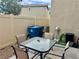Outdoor patio area with a table, chairs, and privacy fencing, perfect for outdoor dining and relaxation at 2872 Atomic Tangerine Way # 2, Las Vegas, NV 89183