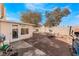 Spacious backyard with brick pavers, outdoor seating, mature trees, and a well-maintained fence at 2903 Galena Peak Ln, Las Vegas, NV 89156