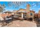 Backyard featuring brick pavers, an outdoor dining area, an enclosed sunroom, and mature landscaping at 2903 Galena Peak Ln, Las Vegas, NV 89156