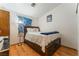 Cozy bedroom featuring a wooden bed frame on wood floor and a lamp at 2903 Galena Peak Ln, Las Vegas, NV 89156
