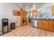Traditional kitchen featuring wood cabinets, stainless steel appliances, and tile floors at 2903 Galena Peak Ln, Las Vegas, NV 89156