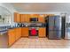 Bright kitchen with wood cabinets, stainless appliances, and tile floors at 2903 Galena Peak Ln, Las Vegas, NV 89156